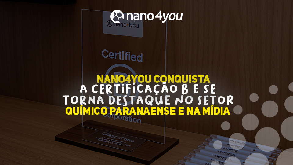 Placa de acrílico representando a Certificação B Corporation conquistada pela Nano4you, exibida sobre uma mesa de madeira, com o logotipo da empresa ao fundo. O destaque da imagem é a premiação que reforça o reconhecimento da Nano4you como referência em sustentabilidade no setor químico paranaense.